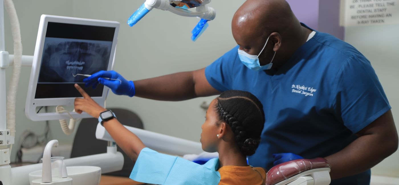 Dentist reviewing a dental X-ray with a patient at Donau Dental Center